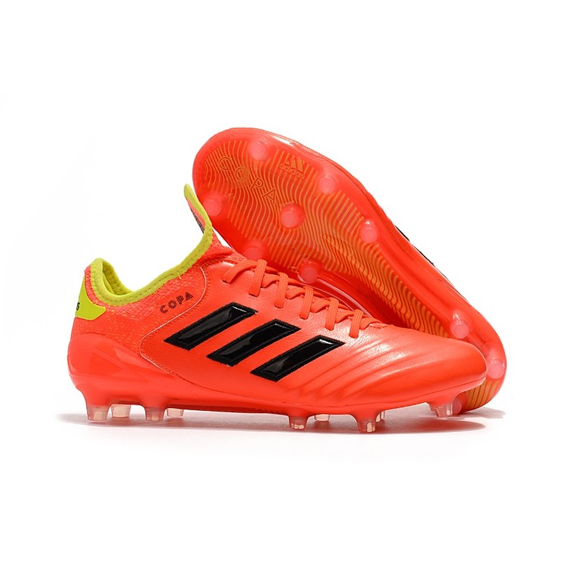 orange and black adidas soccer cleats